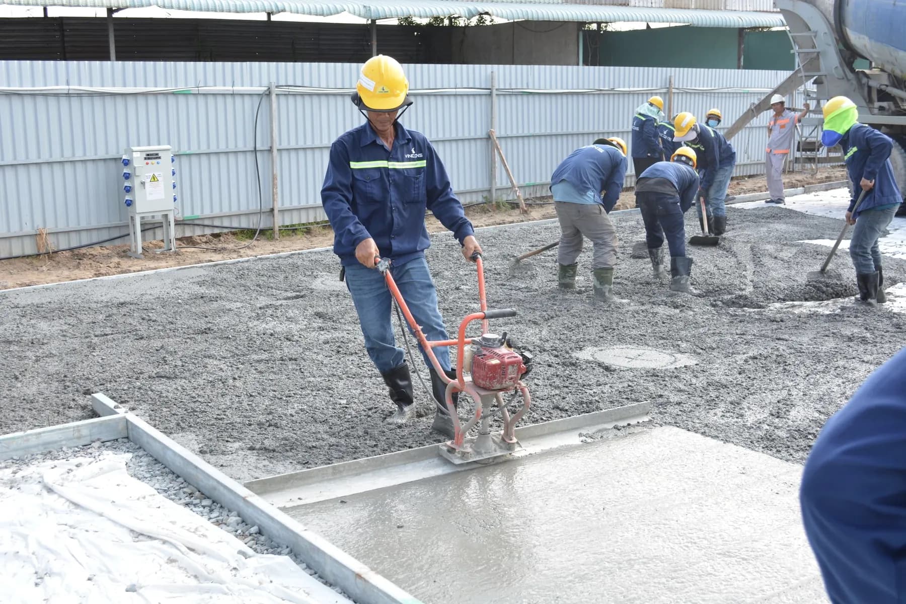 Crew placing and screeding concrete flatwork — Baltimore area, MD.