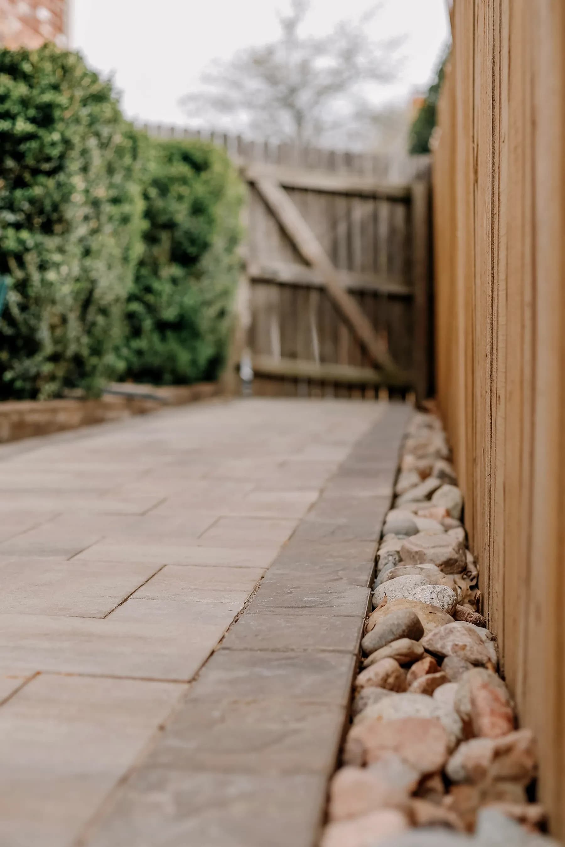 Natural stone walkway with stone border along a fence line — Baltimore area, MD.