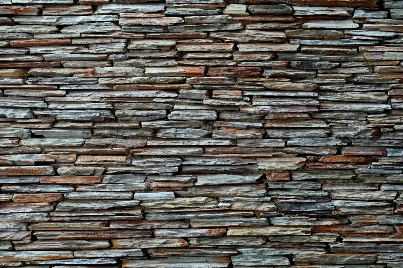 Close-up texture of a stacked slate stone wall.