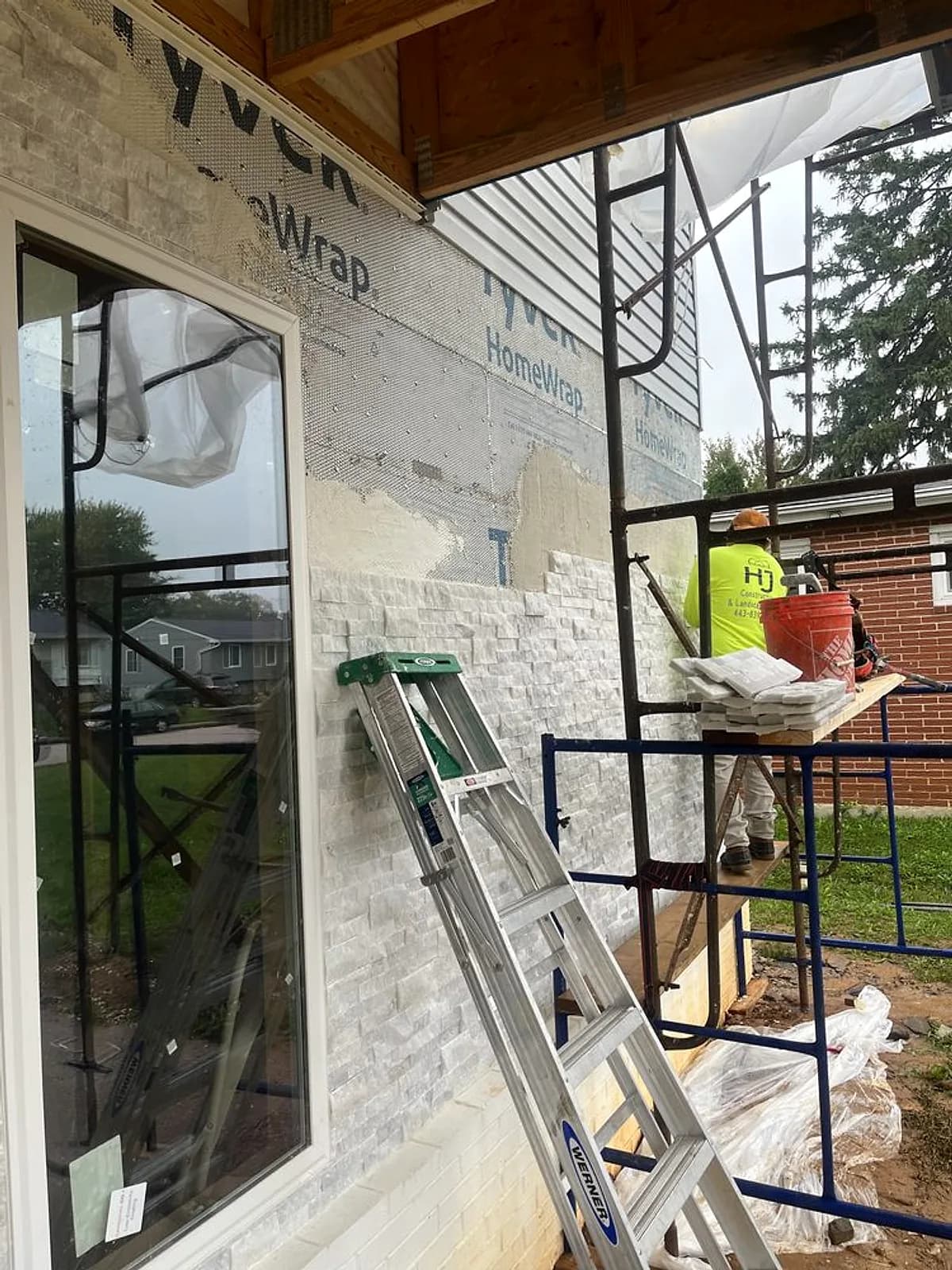 HJ Construction crew installing stacked-stone veneer — Baltimore area, MD.