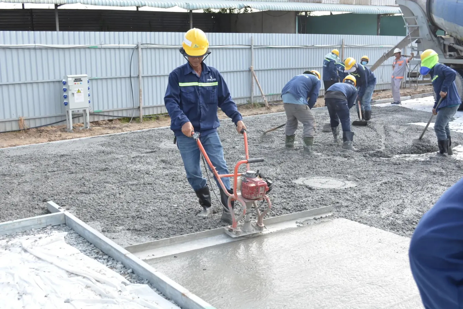 Crew placing and screeding concrete flatwork — Baltimore area, MD.