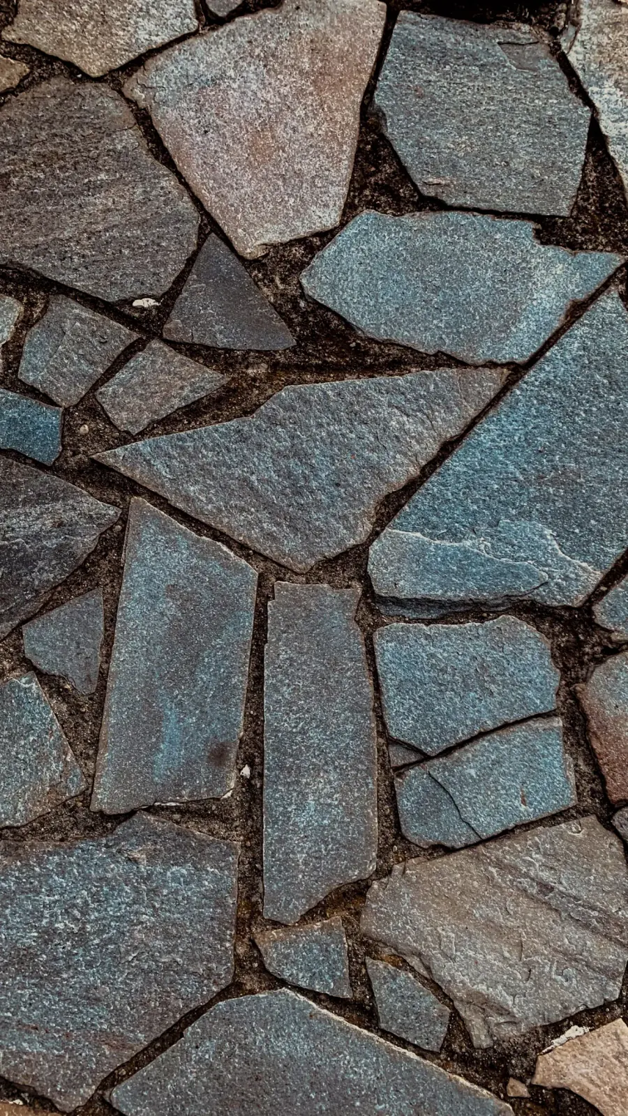 Close-up of bluestone flagstone with tight mortar joints.